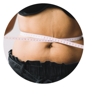 woman that wants tummy tuck measuring stomach